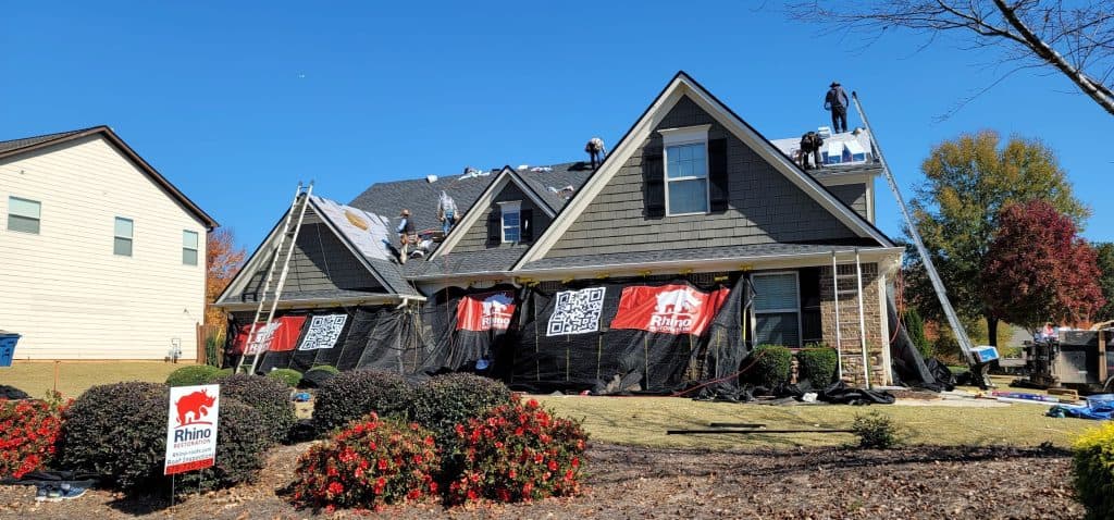 Rhino Restoration specialists inspecting and documenting a storm-damaged Georgia roof