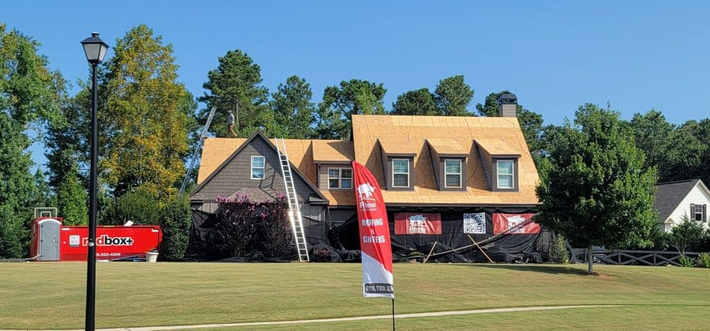 Rhino Restoration roof replacement with protective barriers around a Marietta home